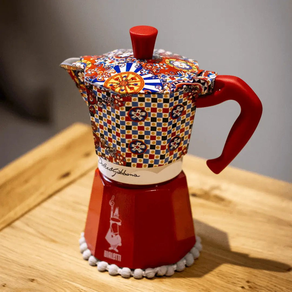 Bialetti Sicilian Cart Moka Express coffee maker with Dolce&Gabbana branding and colorful Sicilian-inspired design.