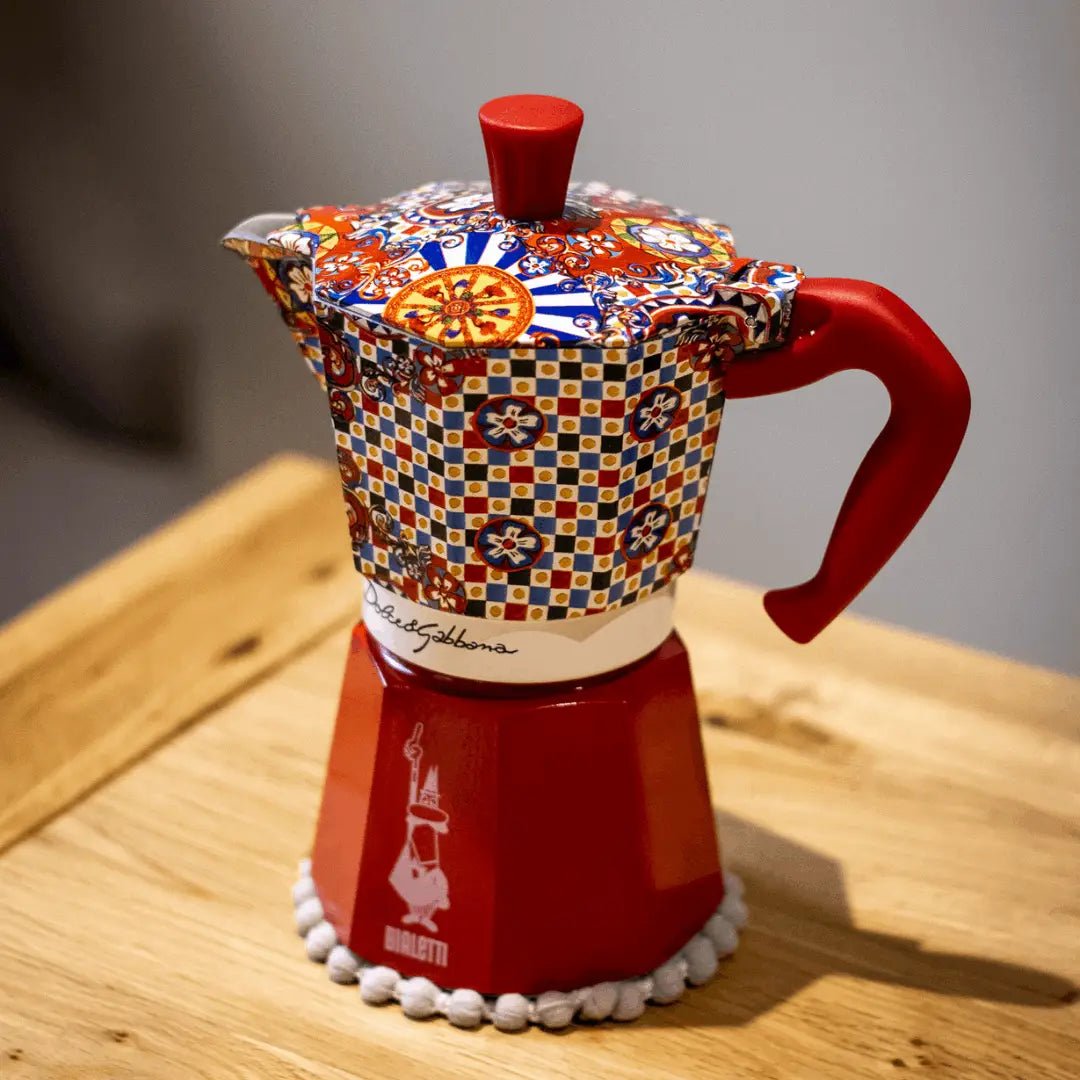 Bialetti Sicilian Cart Moka Express coffee maker with Dolce&Gabbana branding and colorful Sicilian-inspired design.