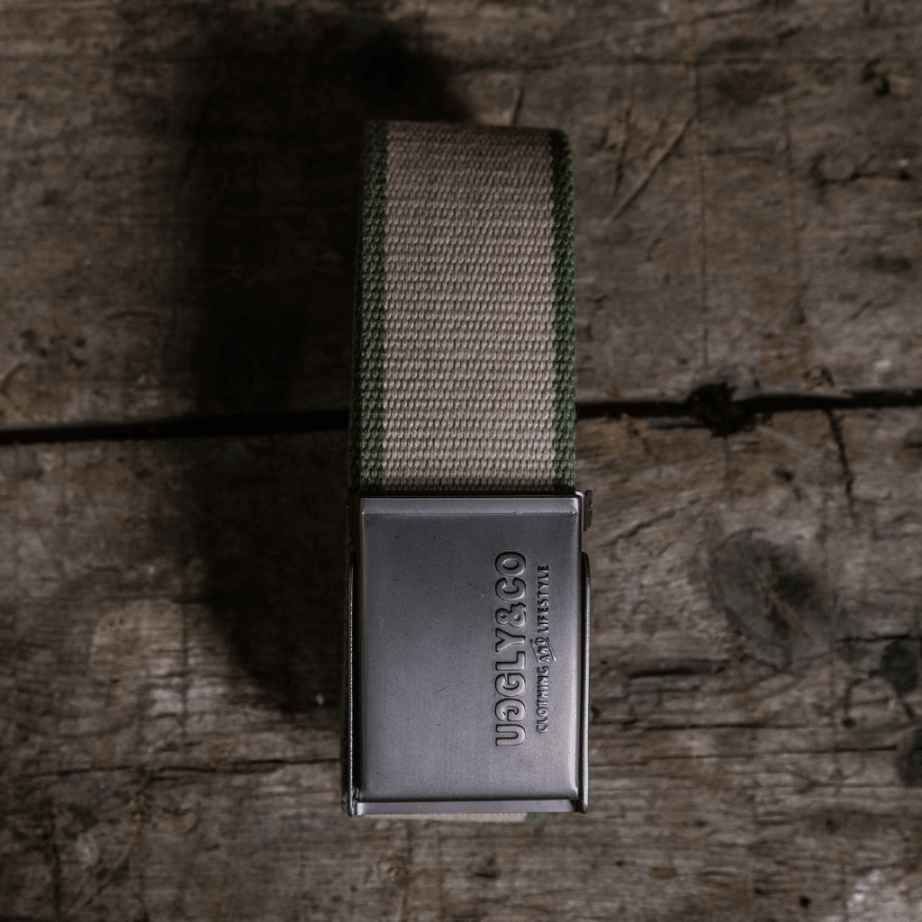 Green canvas utility belt by Uggly and Co with metal buckle, designed for casual wear and functional accessories.