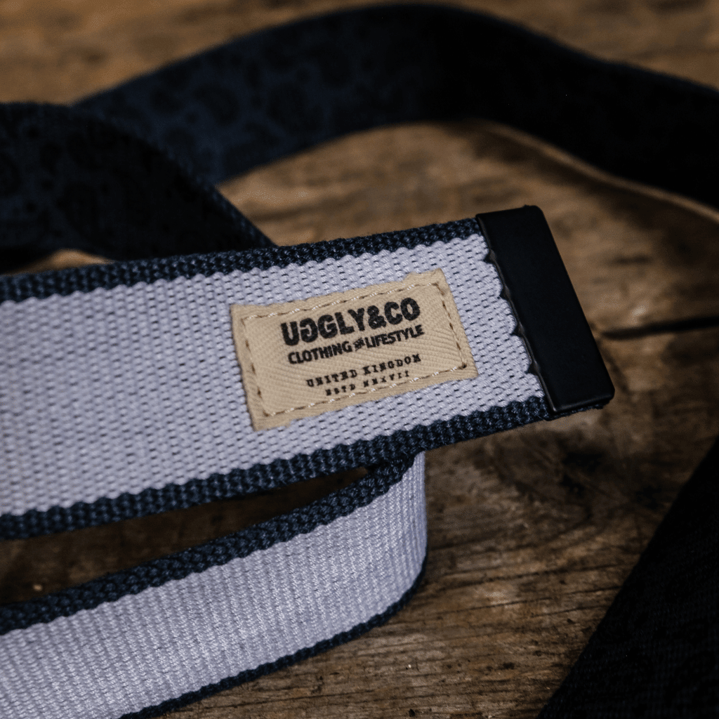 Blue canvas utility belt from Uggly and Co featuring adjustable straps and metal buckle, designed for casual accessories.