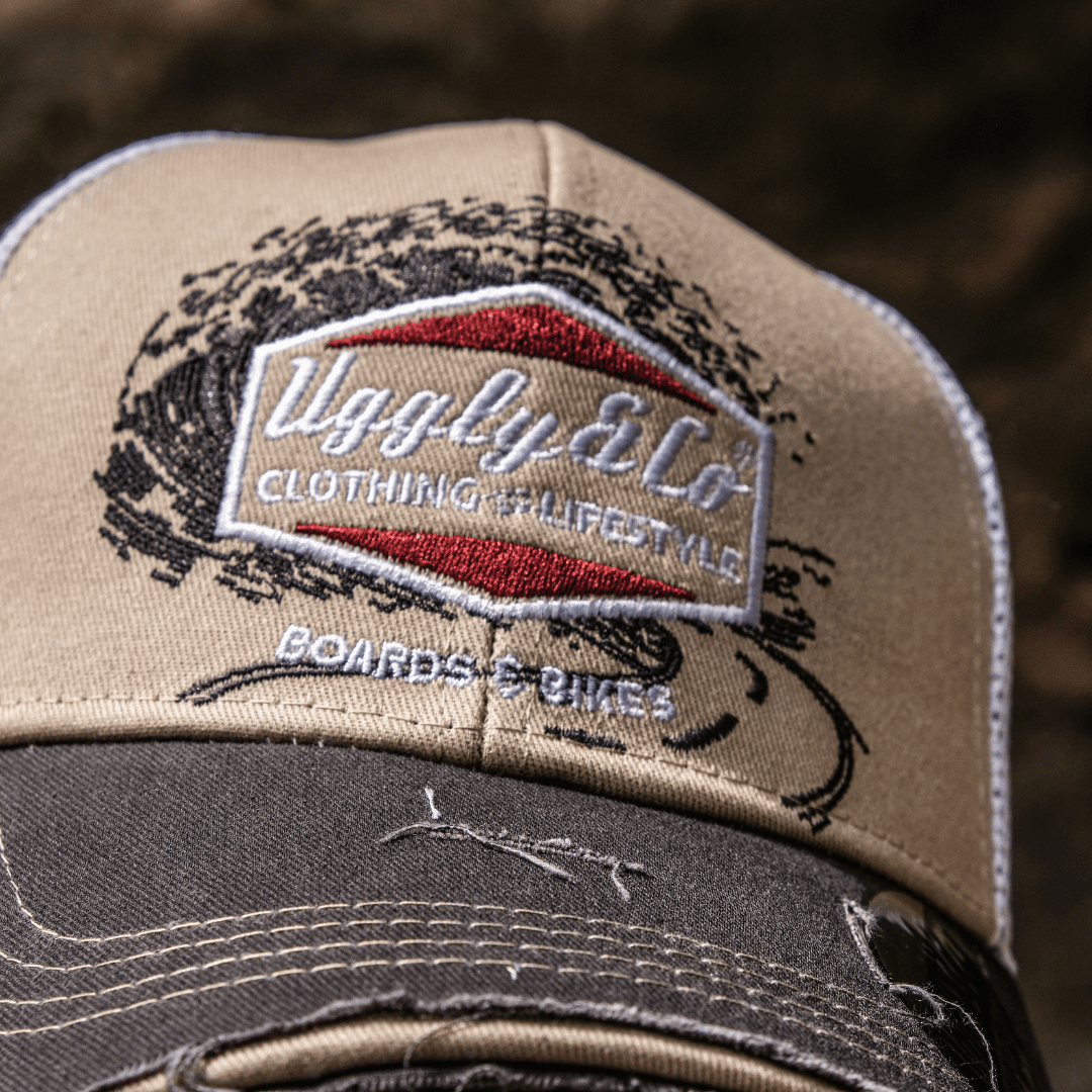 Beige Surf Diamond Uggly and Co trucker hat with mesh back and curved brim, suitable for casual outdoor wear.