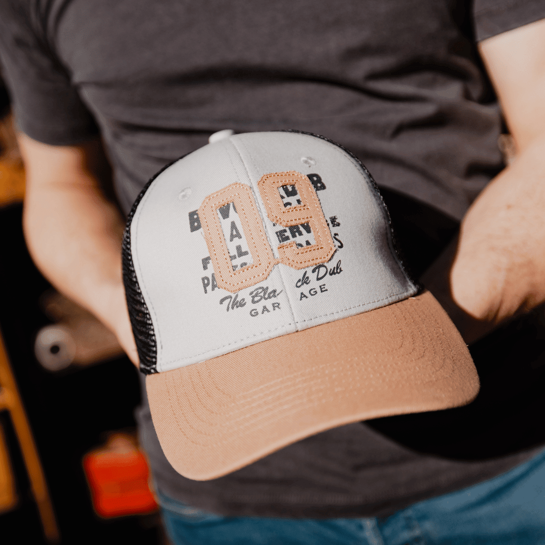 Uggly and Co '09' trucker hat featuring motorcycle-themed design on mesh cap, casual headwear for motorcycle enthusiasts.