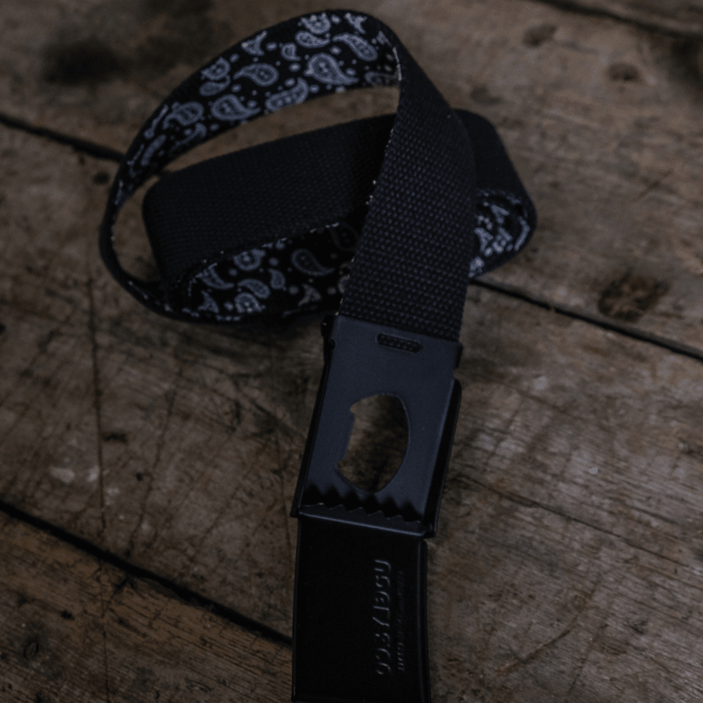 Black canvas utility belt by Uggly and Co with multiple pouches, designed for motorcycle riding and outdoor accessories.