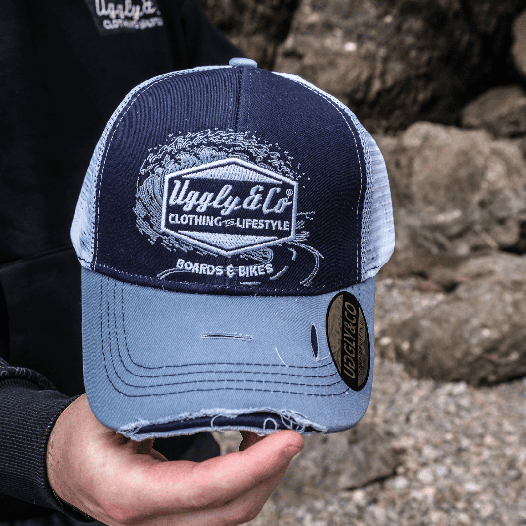 Blue Uggly and Co surf diamond trucker hat featuring a classic mesh back and adjustable snap closure.