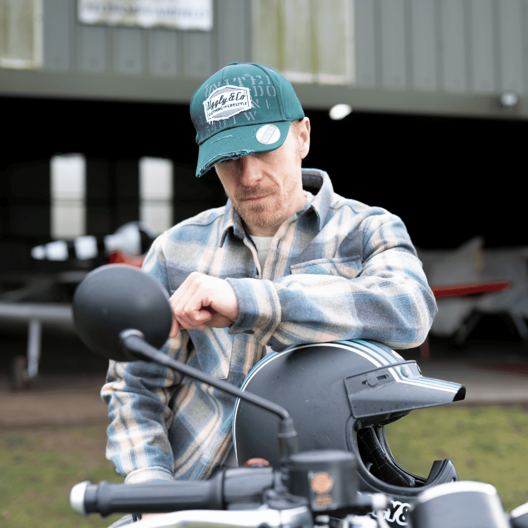 Green Uggly and Co Aviation diamond trucker hat featuring a baseball cap style with embroidered aviation design.