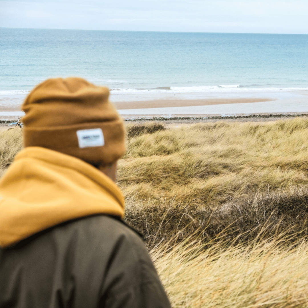 Uggly and Co mustard beanie with a cozy knit texture, designed for warmth and style, suitable for casual outdoor wear.
