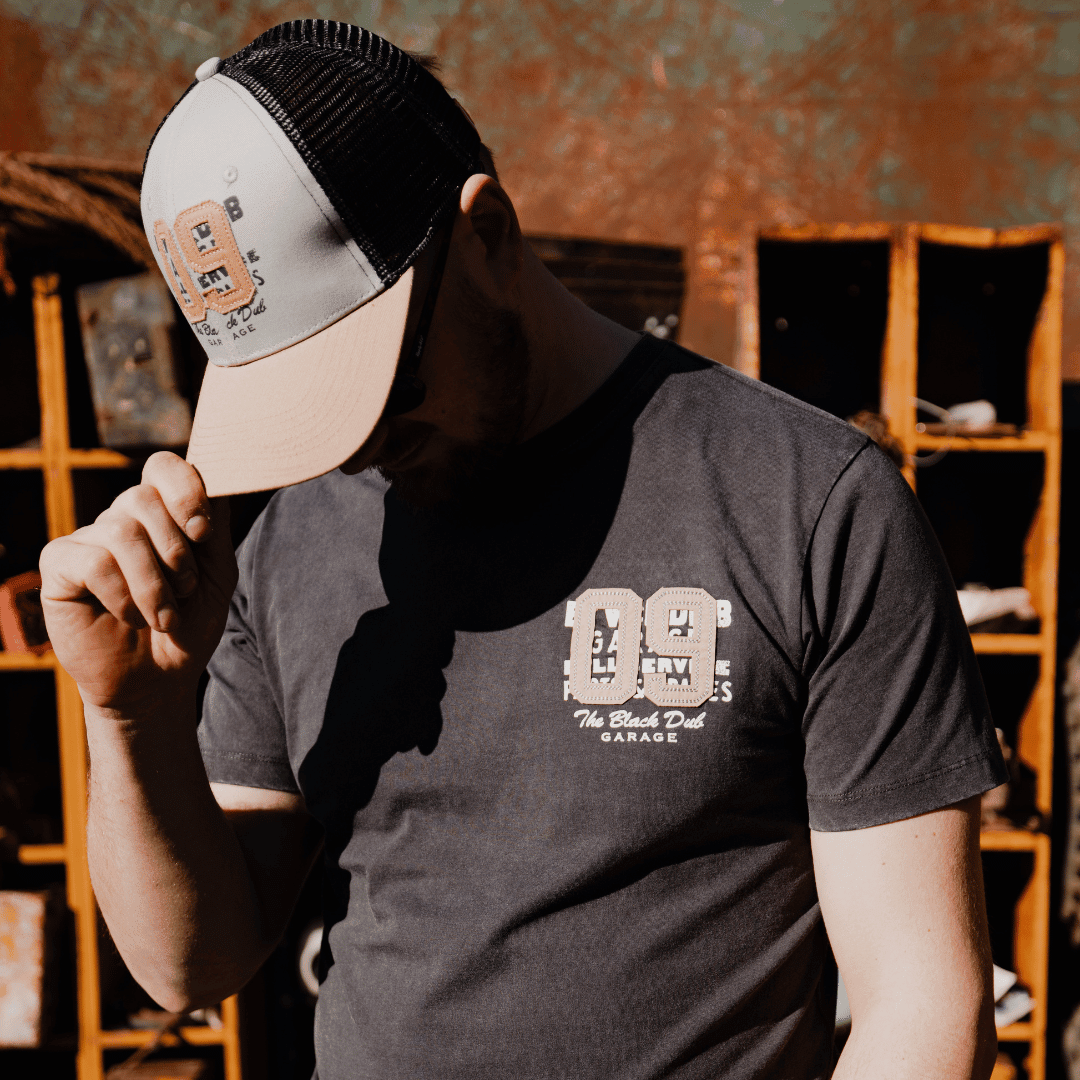 Uggly and Co '09' trucker cap with stone parts design, adjustable mesh back, and structured front panel for casual motorcycle style.