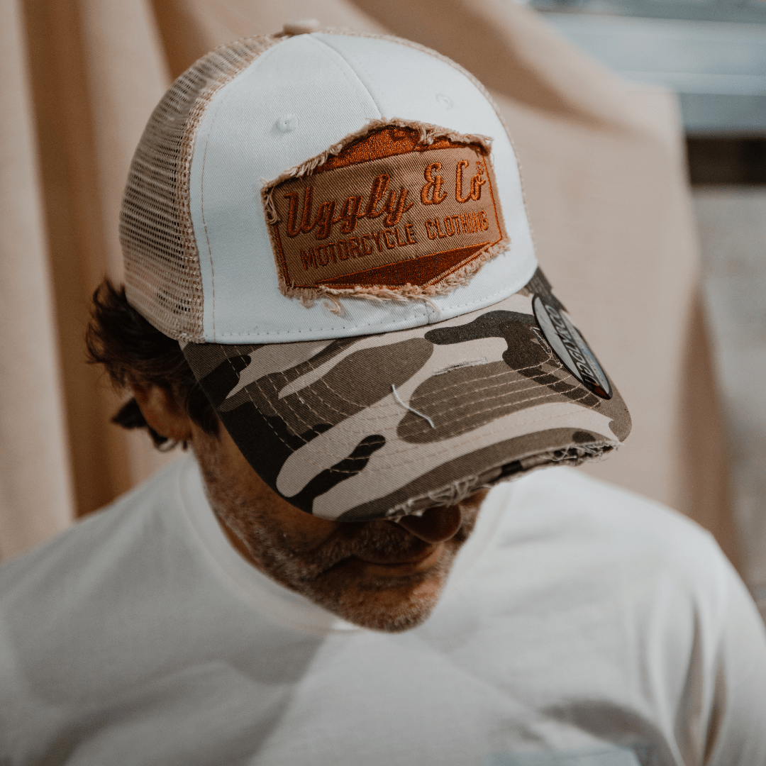 Uggly and Co camo diamond trucker hat with mesh back and curved brim, featuring a diamond pattern design.