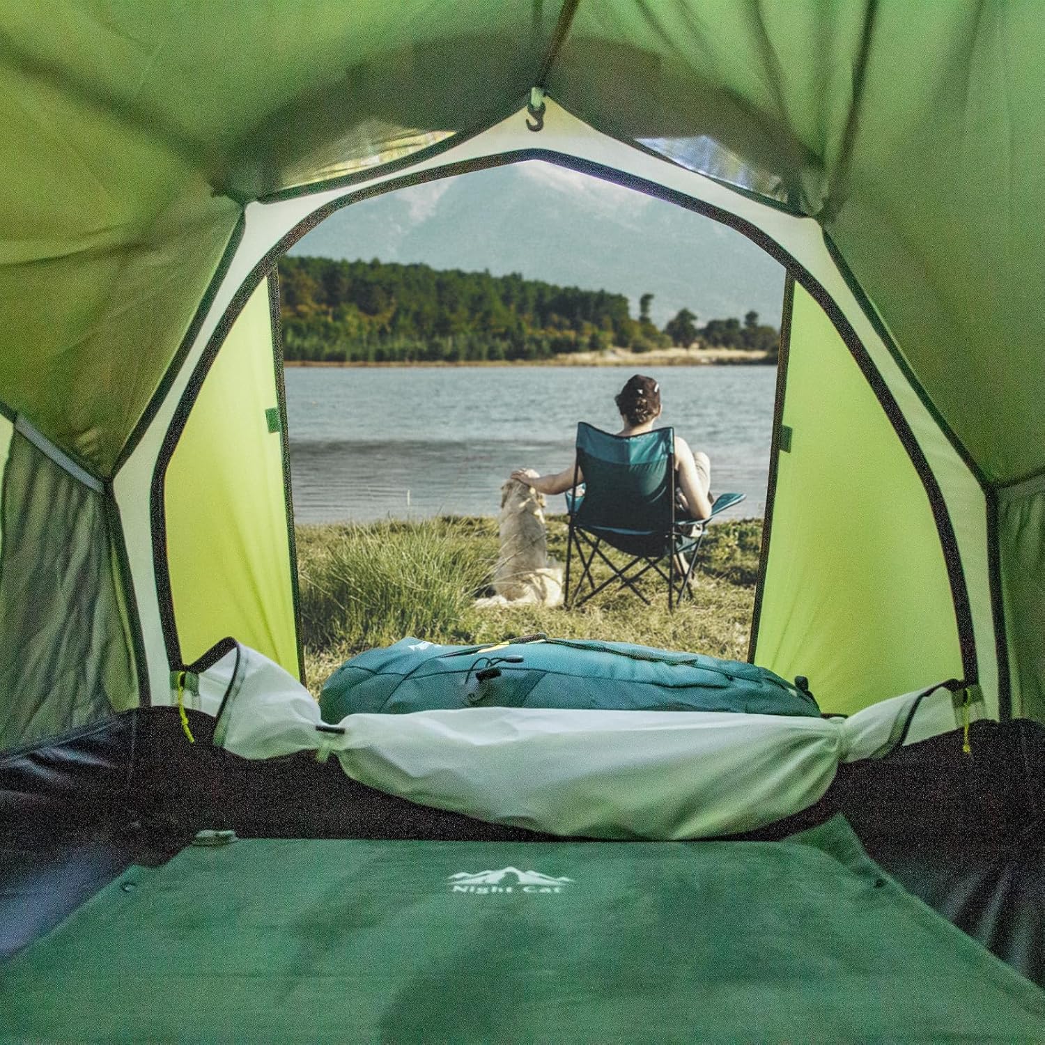Inside view of HikeWare Night Cat ultralight 1-person tunnel tent by a lake, showing waterproof fabric and spacious interior.