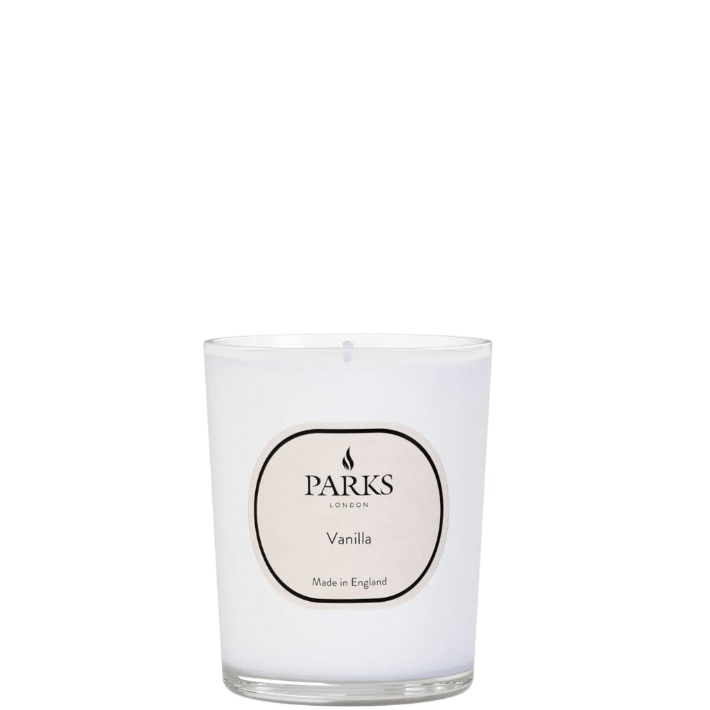 Vanilla candle from Parks Candles, 180g, with a white glass jar and a lit wick, showcasing a cozy, soothing ambiance.