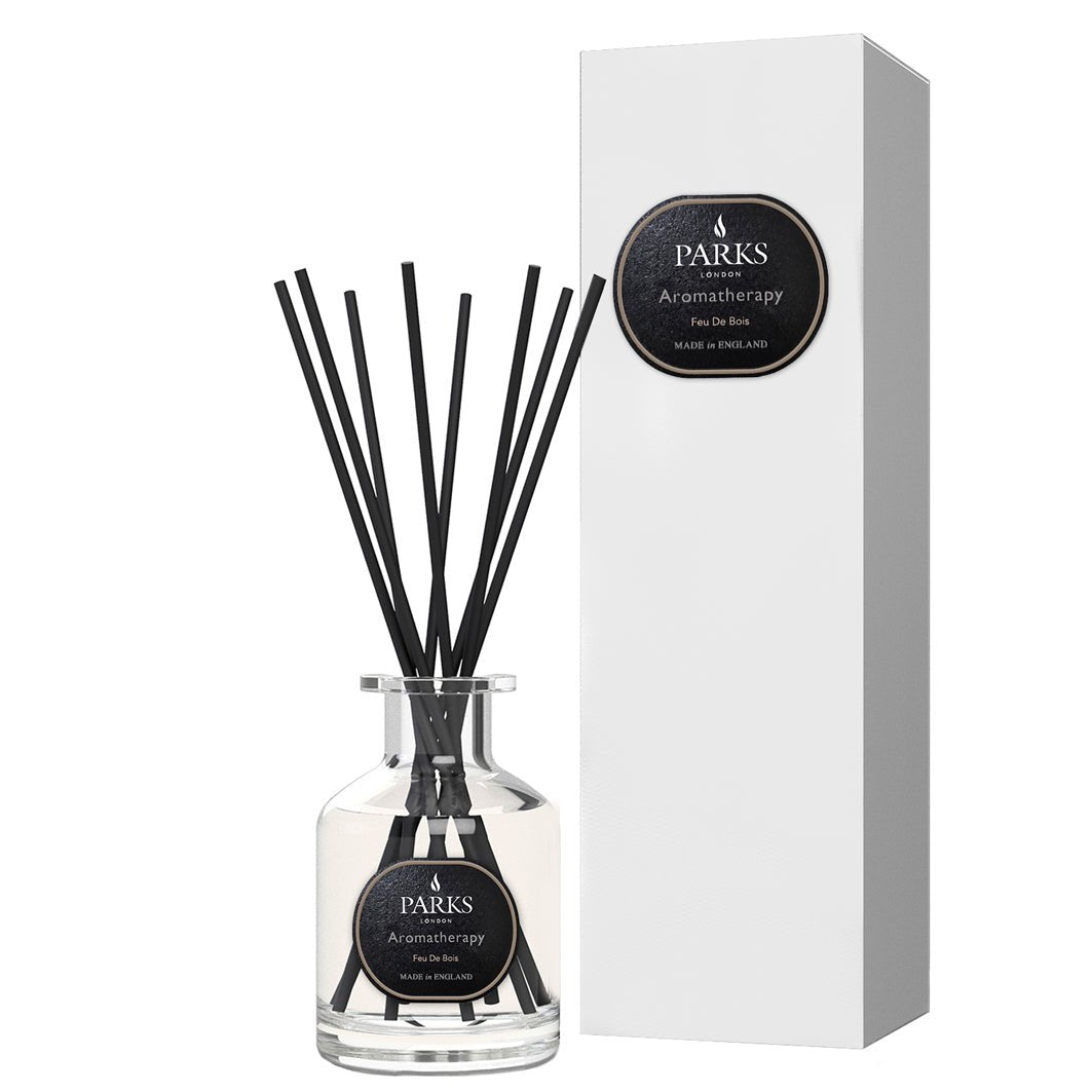 Parks Candles Feu de Bois reed diffuser 100ml with elegant glass bottle and reed sticks for a warm, woody fragrance.