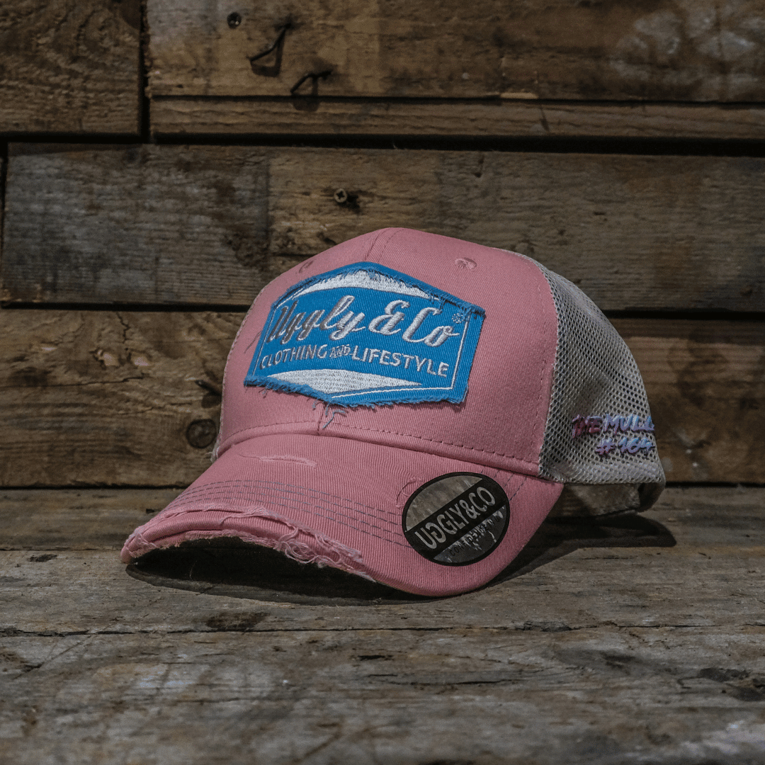 Pastel pink and blue diamond trucker cap by Uggly and Co featuring a mesh back and adjustable snap closure.