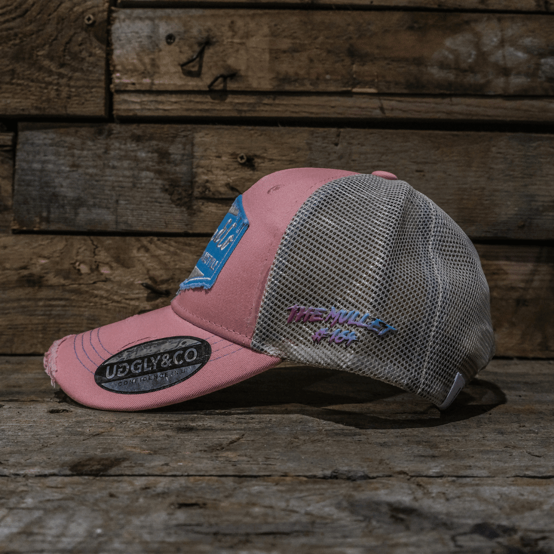 Pastel pink and blue diamond trucker cap by Uggly and Co featuring a classic mesh design and adjustable snapback closure.