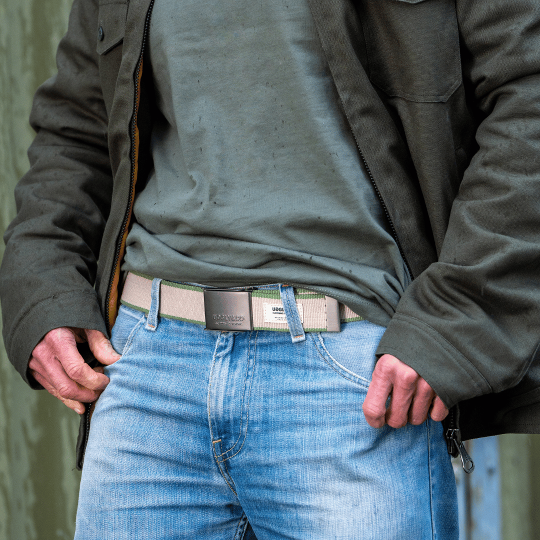 Green canvas utility belt with multiple pouches, featuring Uggly and Co branding, designed for practical accessories and outdoor use.
