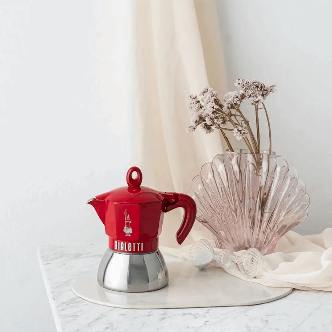 Red Bialetti Moka Induction Exclusive coffee maker with sleek design and stainless steel finish, suitable for induction stovetops.
