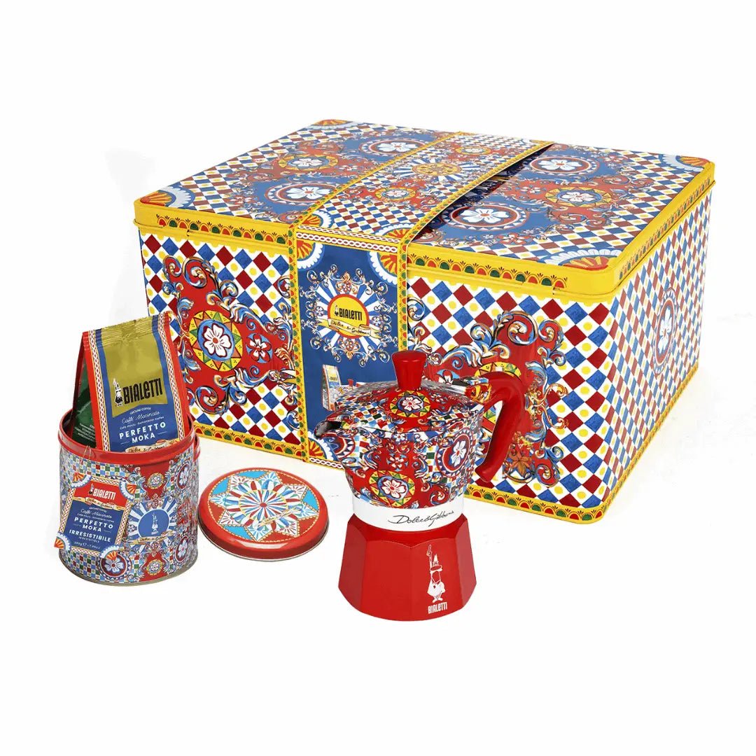 Red Bialetti Moka Express 3-cup coffee maker with Dolce&Gabbana Sicilian Cart gift set and coffee for authentic Italian brewing.