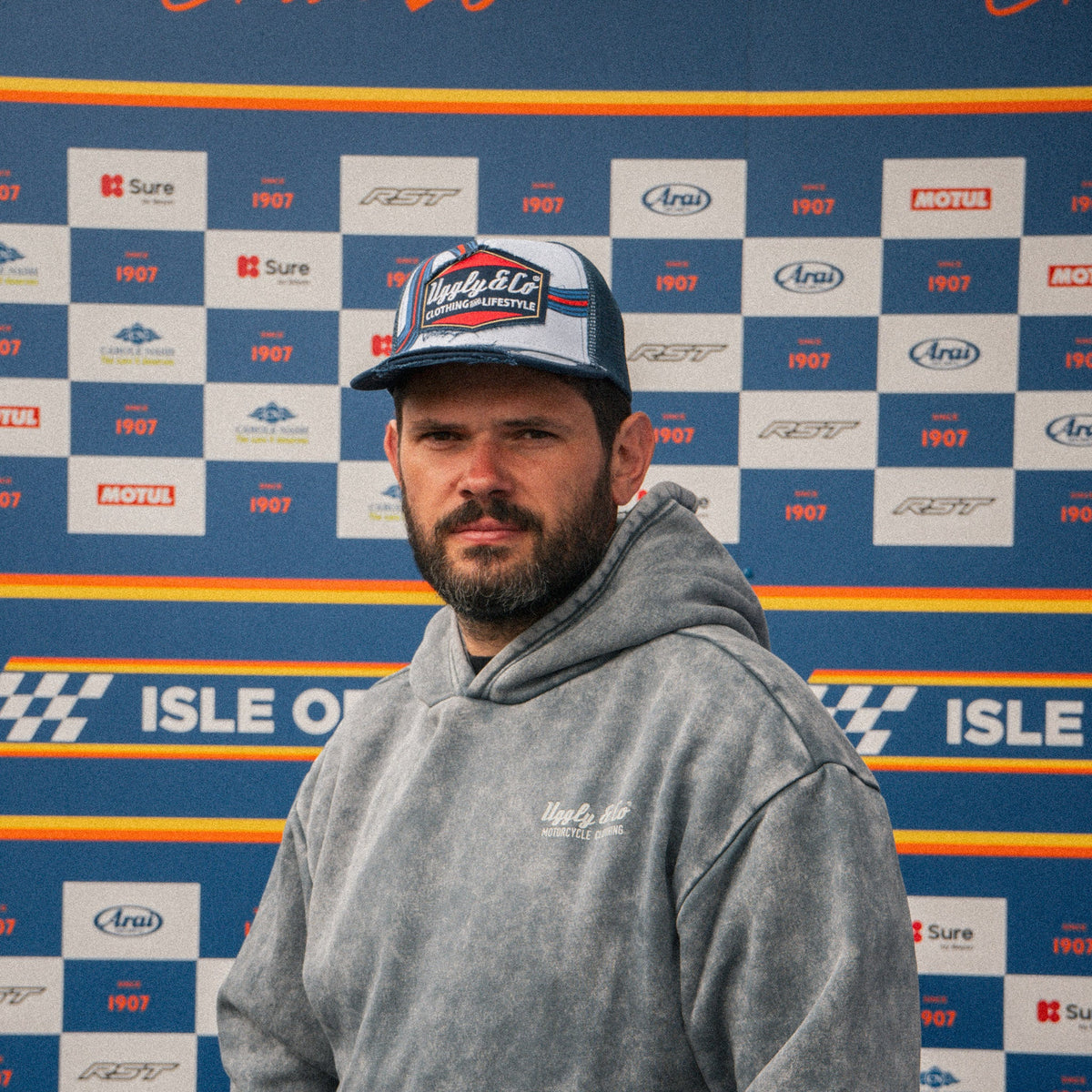 Retro blue and red diamond pattern trucker cap by Uggly and Co, featuring a classic mesh design and adjustable snapback.