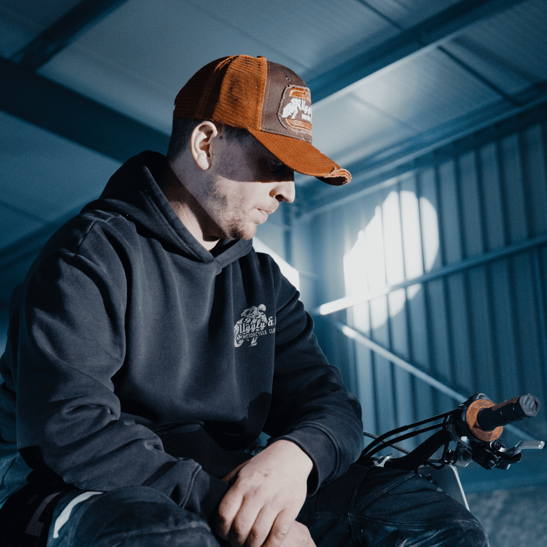 Rust flat track trucker hat by Uggly and Co featuring retro motorcycle design on classic trucker cap style.