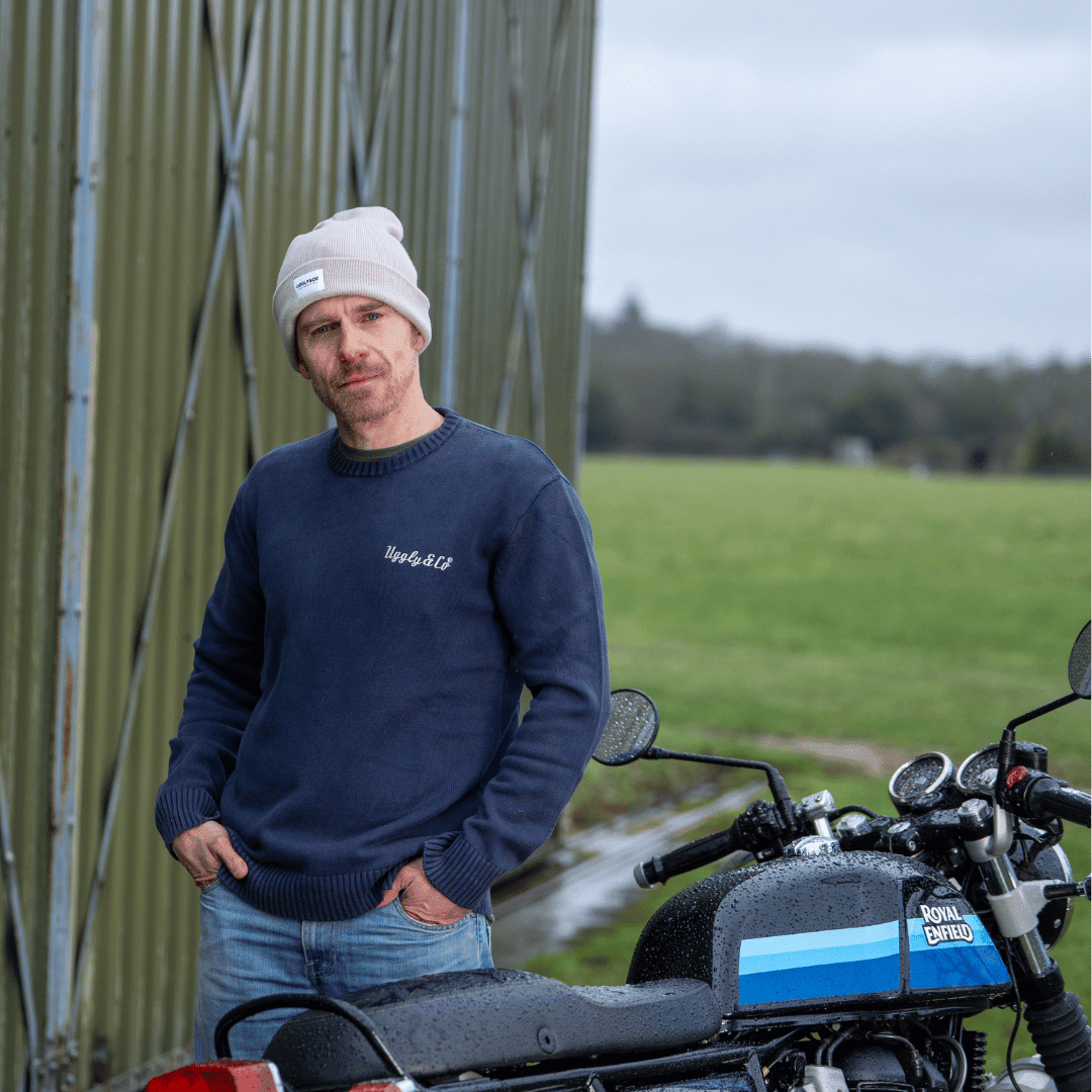 Oatmeal grey Uggly and Co beanie with retro racing mechanic style, featuring a vintage-inspired knit design.