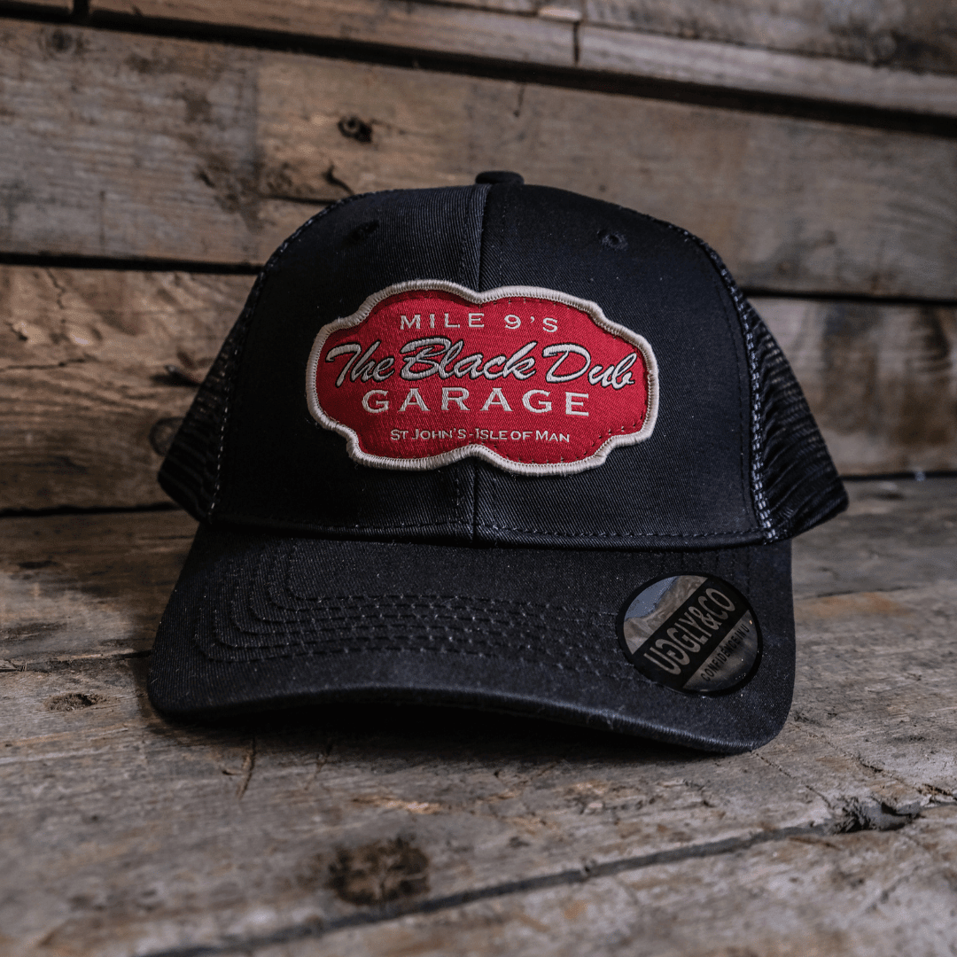 Black Dub Garage Trucker Hat by Uggly and Co featuring a classic trucker cap design with mesh back and embroidered front panel.
