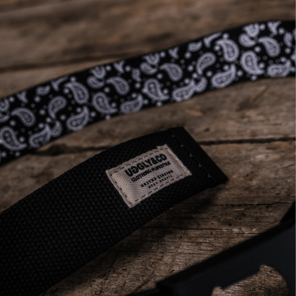 Black canvas utility belt for bikers by Uggly and Co, featuring durable straps and multiple pockets for accessories.
