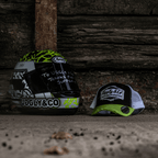 Yellow and white diamond-patterned trucker cap by Uggly and Co, featuring a classic mesh back and adjustable strap.