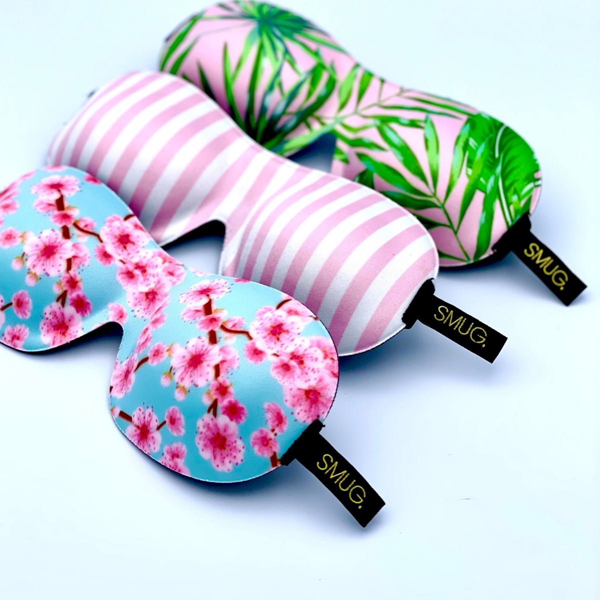 Contoured SMUG blackout sleep mask with cherry blossom and candy shop print, designed for comfortable sleep and blockout.