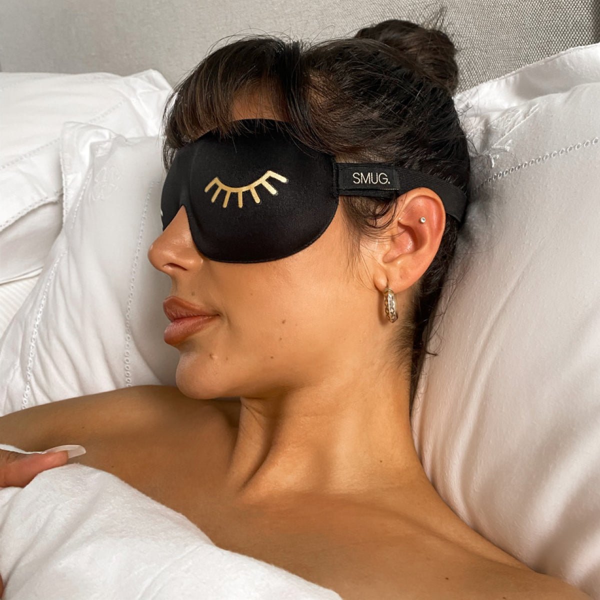 Contoured black sleep mask with Wink print by SMUG, designed for comfortable blackout sleep and eye contouring.