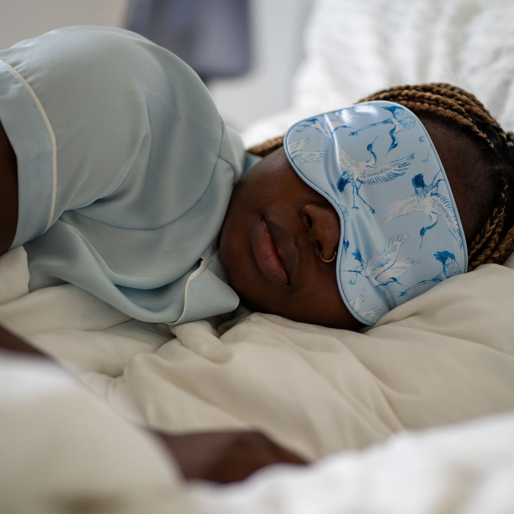 Soft satin sleep mask with elegant cranes print by SMUG, designed for comfortable sleep and relaxation.