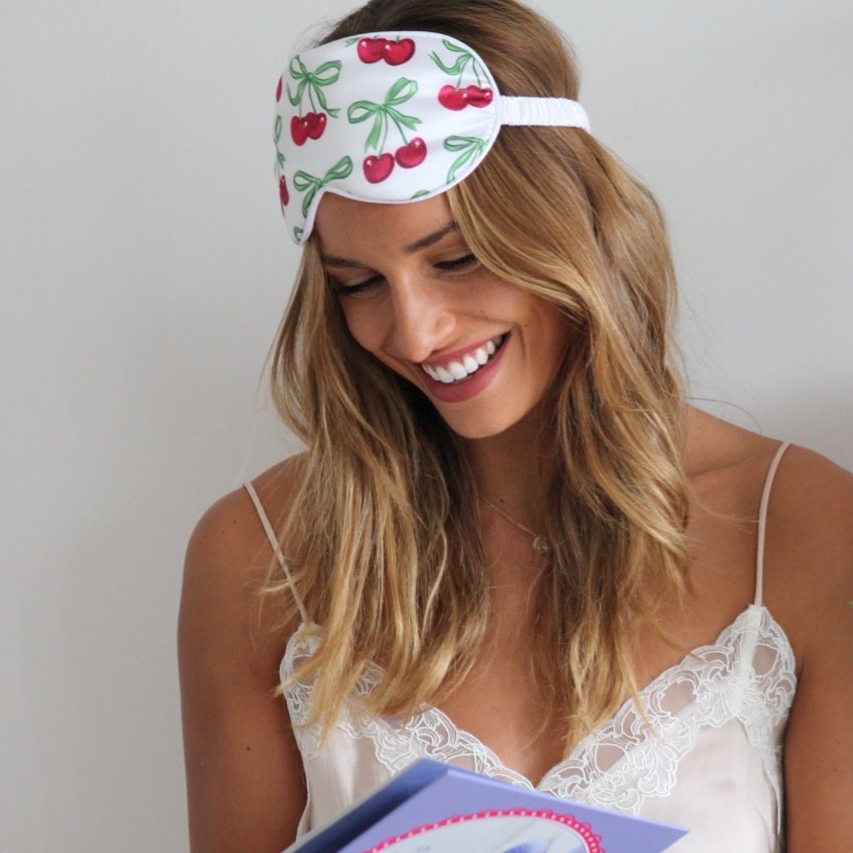 White cherries print satin sleep mask by SMUG, soft and comfortable sleep accessory with a stylish cherry pattern.