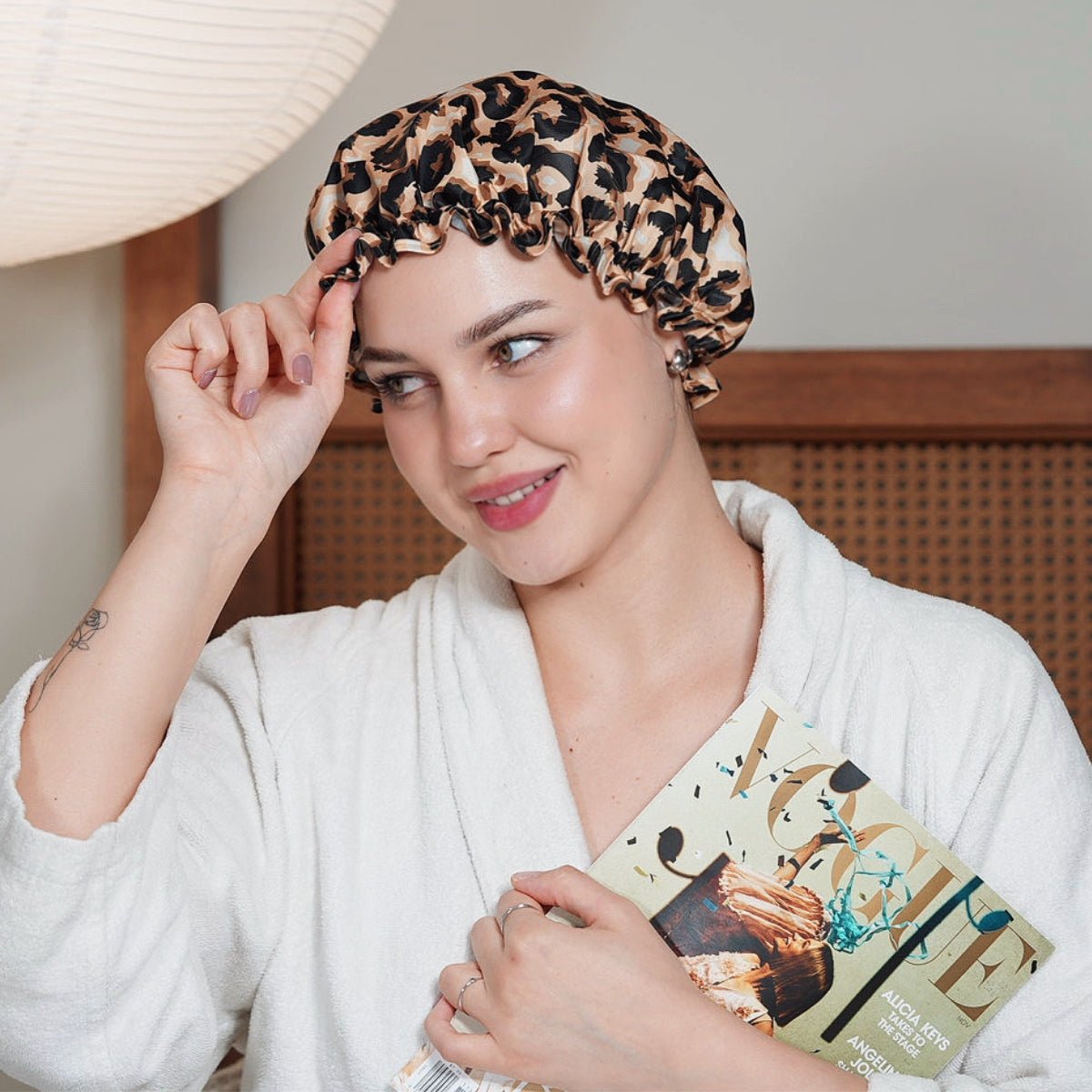 Leopard print SMUG shower cap with elastic edge, ideal for protecting hair during bathing or showering.