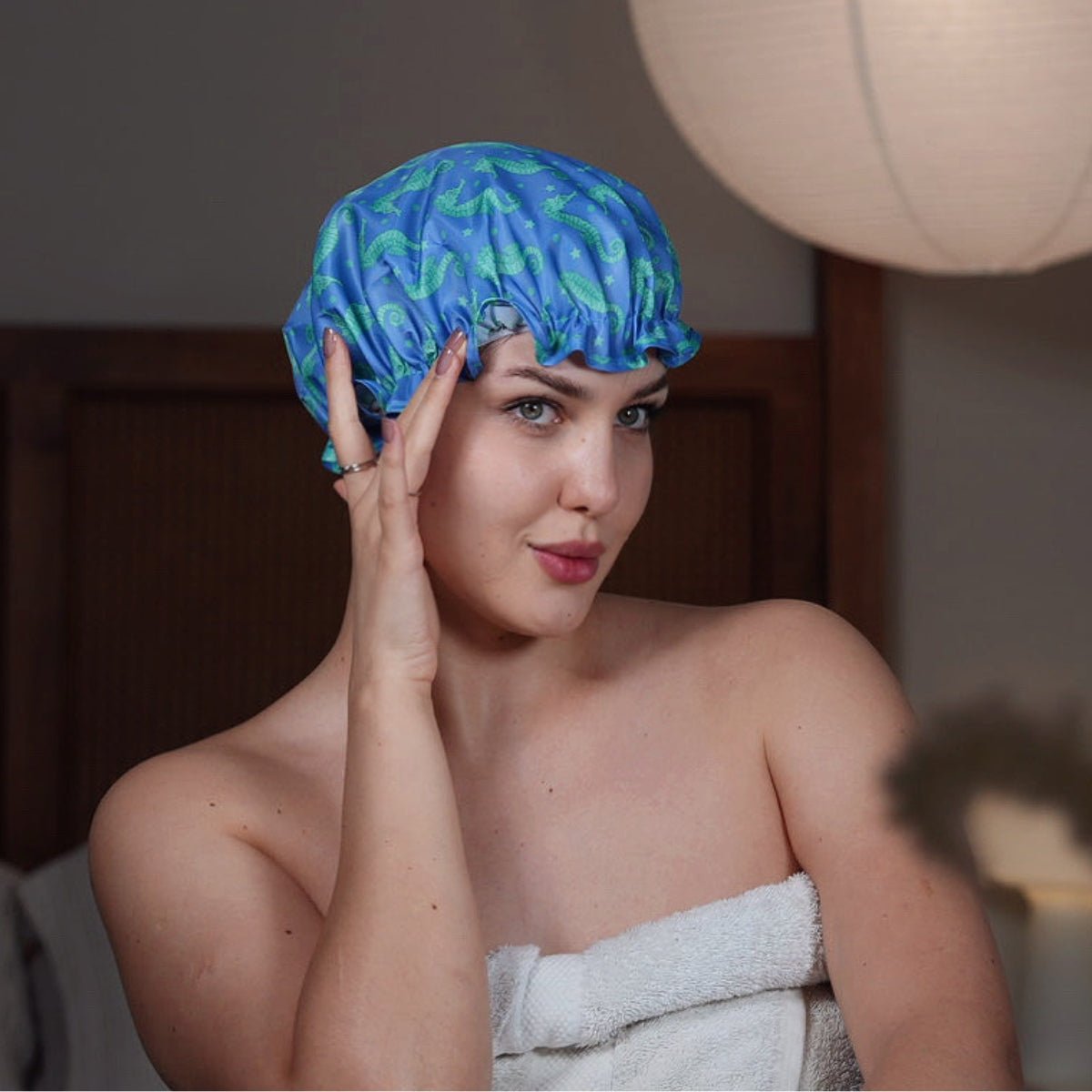 SMUG shower cap with a colorful seahorse print, made from waterproof material, designed to keep hair dry during showers.