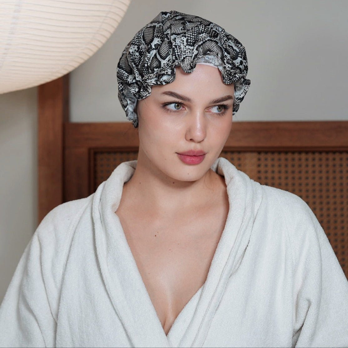 SMUG snake print shower cap made of waterproof material, featuring a stylish snake pattern, designed for hair protection during showers.