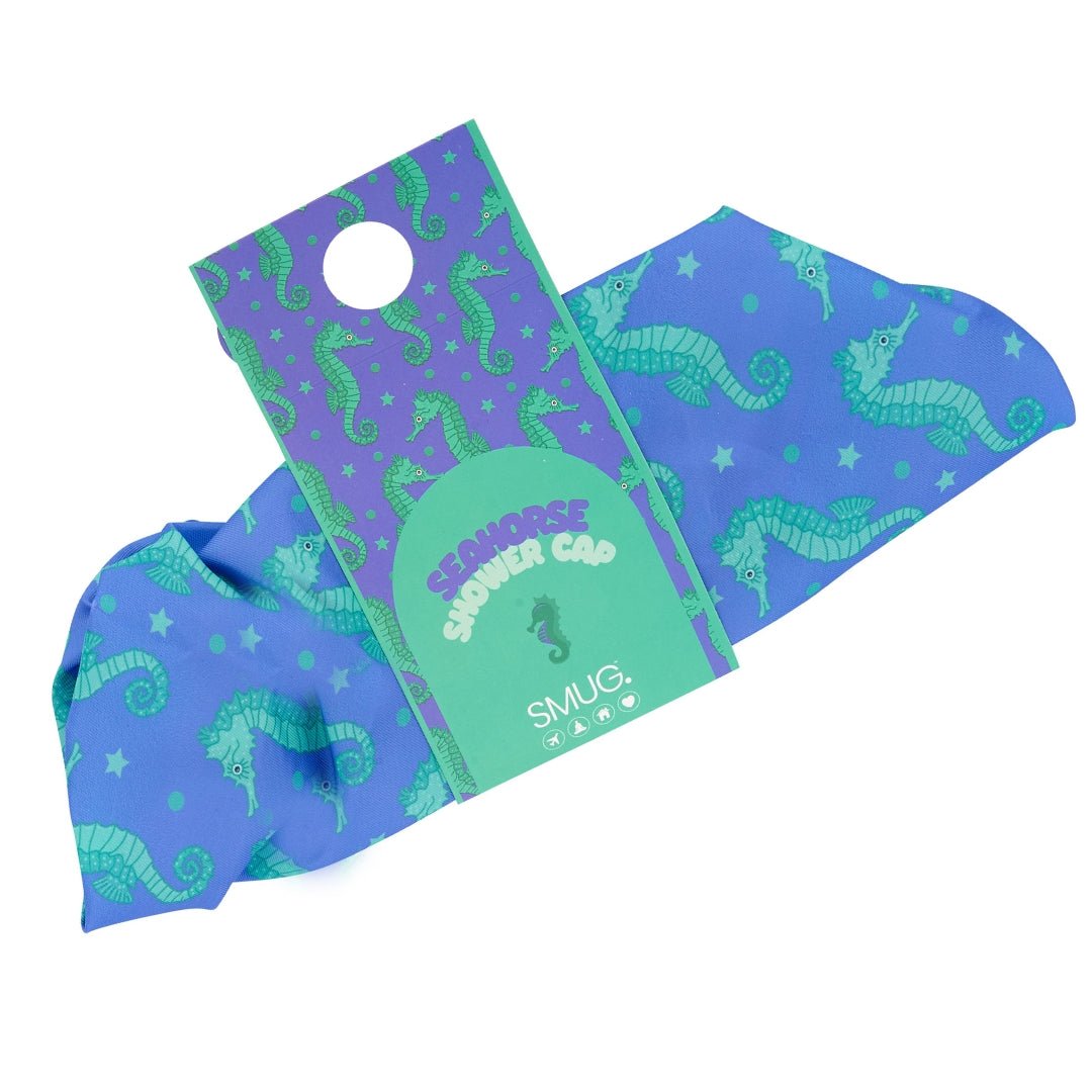 SMUG shower cap with colorful seahorse print, waterproof design, and elastic edge for secure fit during bath or shower.