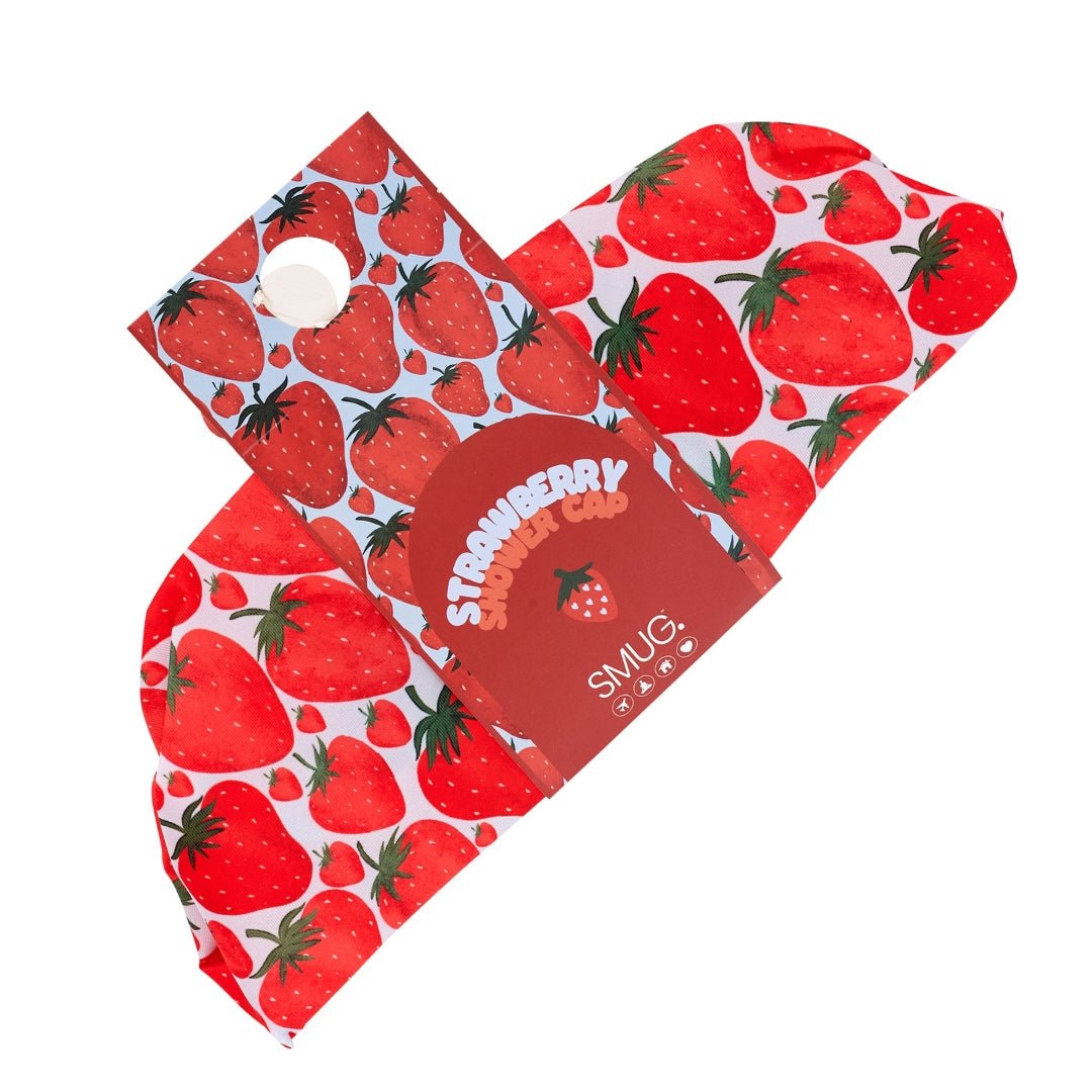 SMUG strawberry print shower cap with waterproof fabric, shown in packaging with vibrant strawberry design.