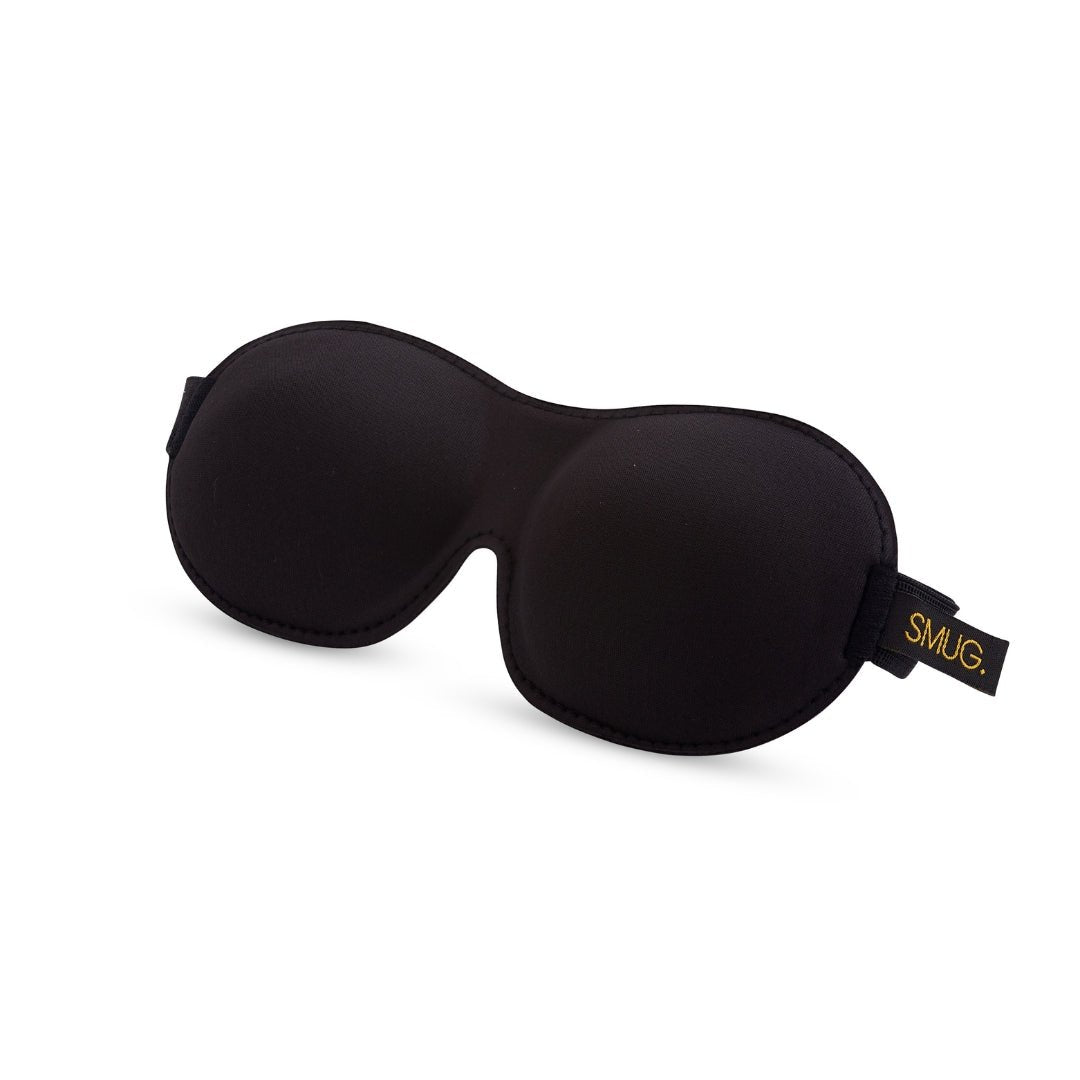 Contoured black SMUG 3D blackout sleep mask showing its soft, padded design and contoured shape for comfortable, complete darkness.