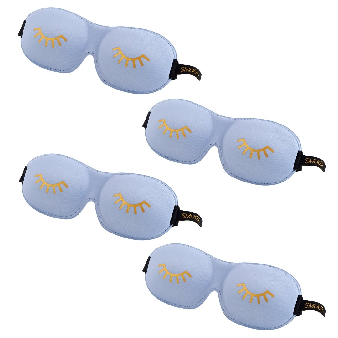 Contoured SMUG sleep mask set in multiple designs, featuring a baby blue sleep mask with a wink illustration.