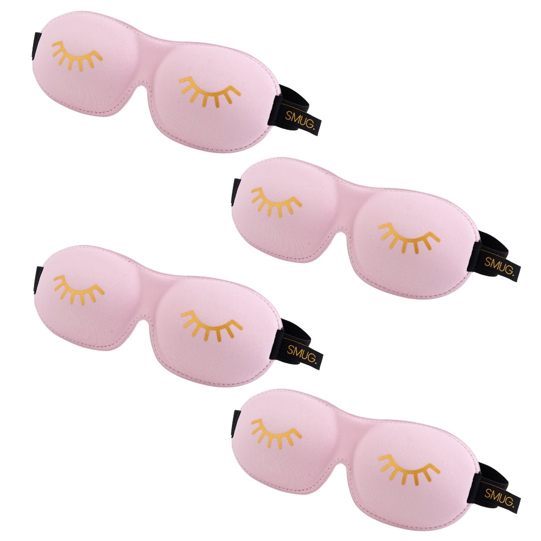 Set of SMUG contoured sleep masks in various designs, including baby pink and wink patterns, for comfortable overnight rest.