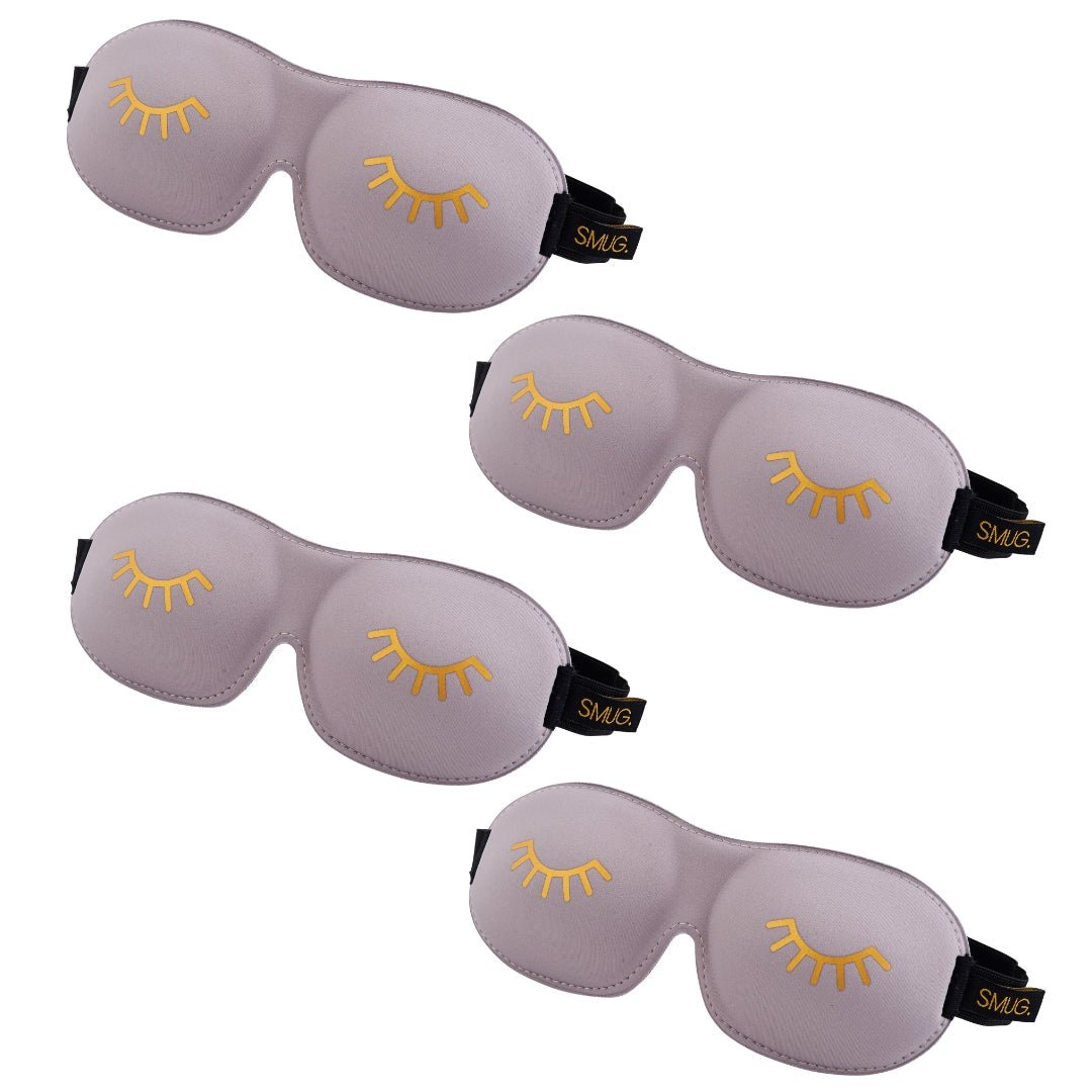Contoured SMUG sleep mask set in grey with a winking design, featuring multiple comfortable eye masks for restful sleep.