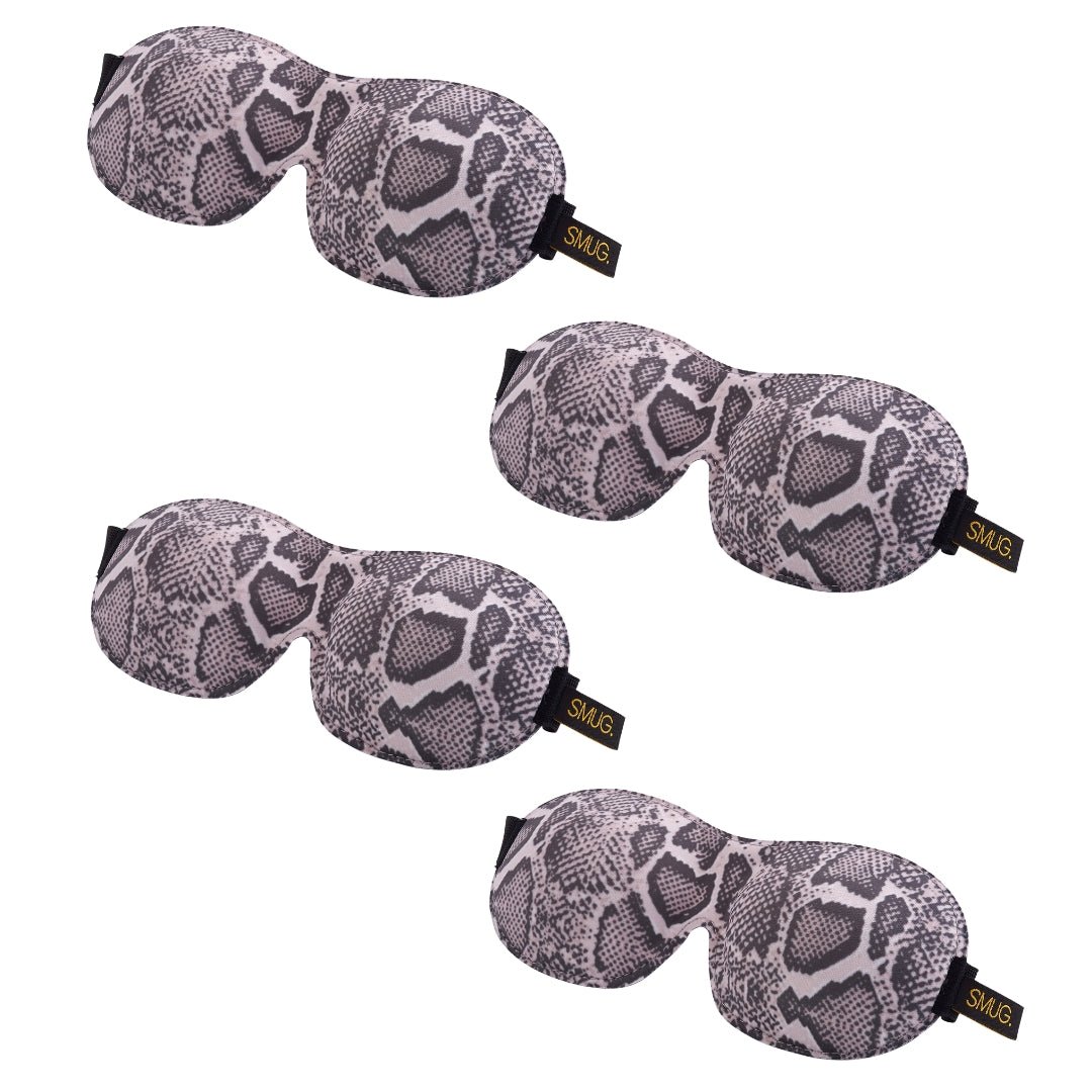 Contoured SMUG sleep mask set with various designs, including a snake pattern, for comfortable, eye-covering sleep aid.