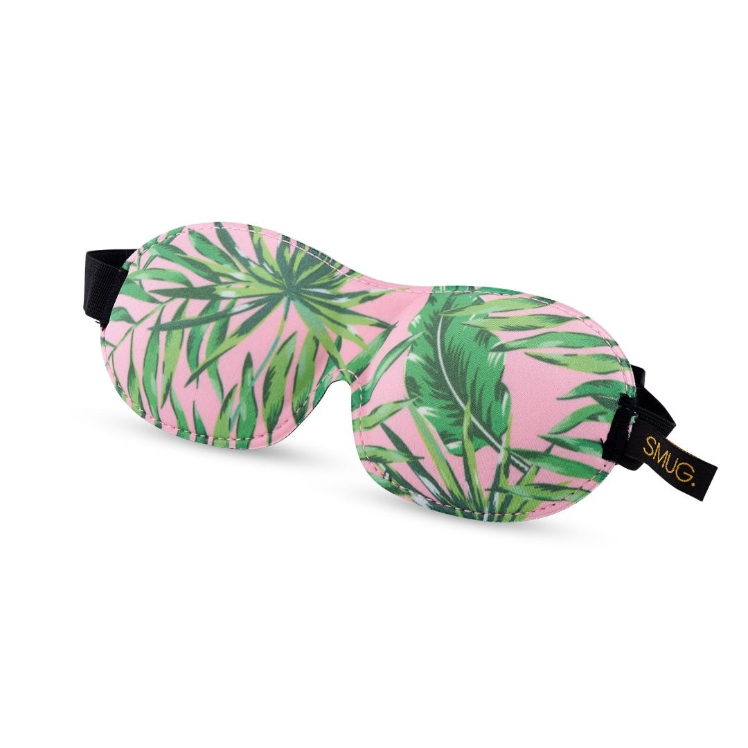Contoured SMUG blackout sleep mask with black fabric and palm print design, designed to block light for restful sleep.