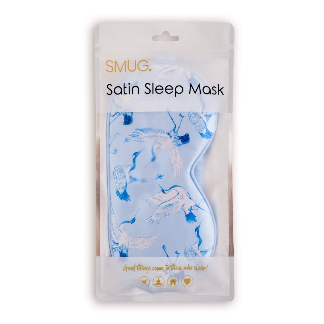 SMUG satin sleep mask with elegant cranes print, shown in packaging for comfortable, luxurious sleep.