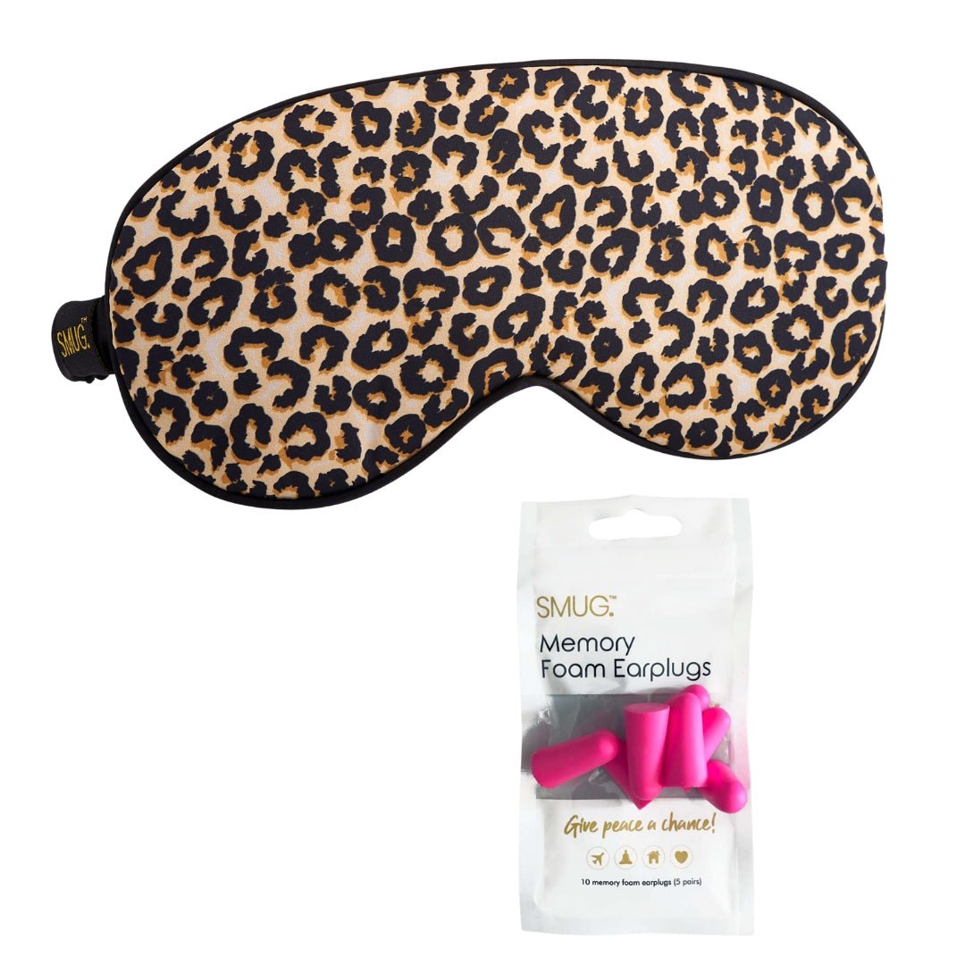 Pink satin sleep mask with leopard print and matching earplugs, designed for comfortable sleep by SMUG.