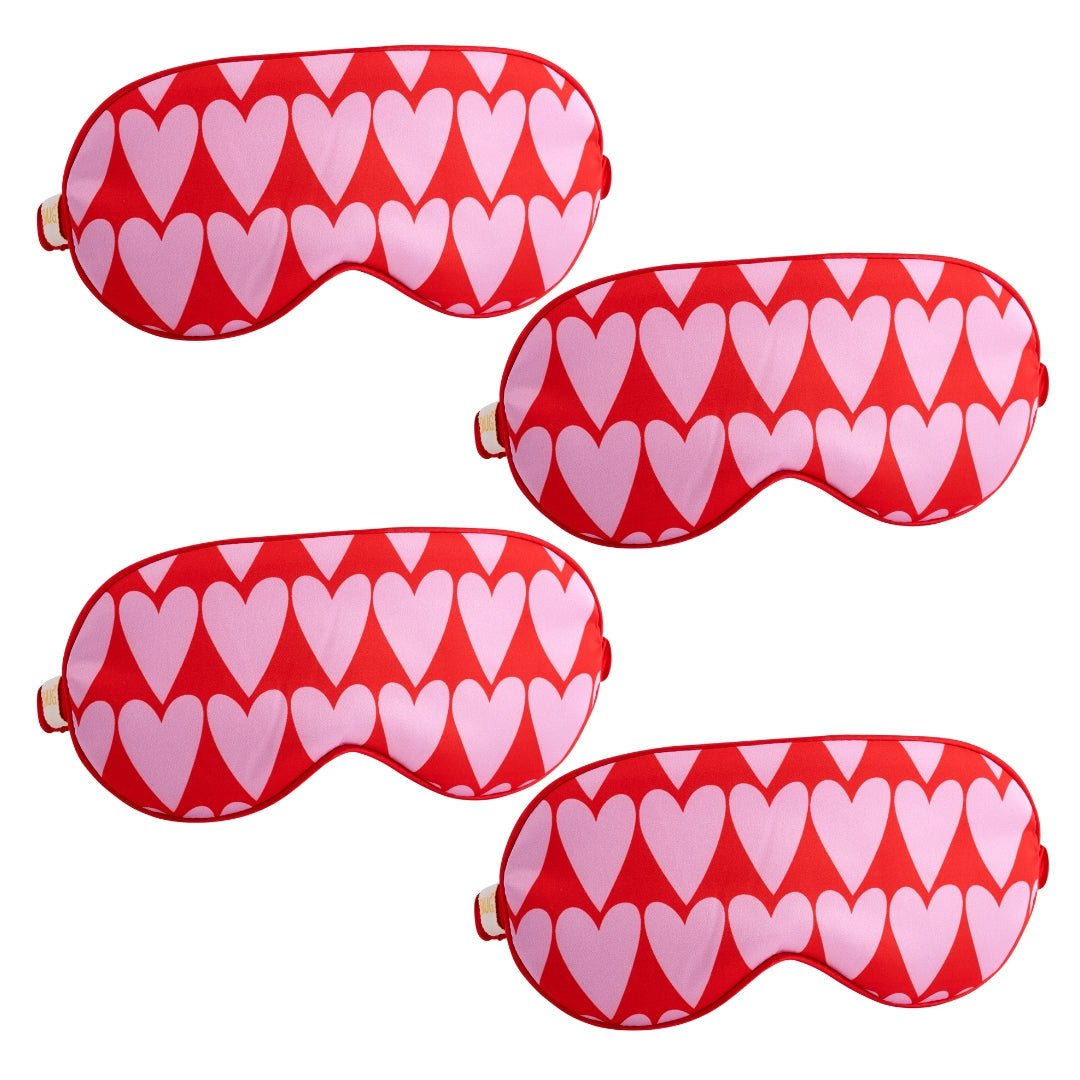 Set of SMUG satin sleep masks with various designs, including a long heart pattern, made for comfortable, stylish nighttime wear.
