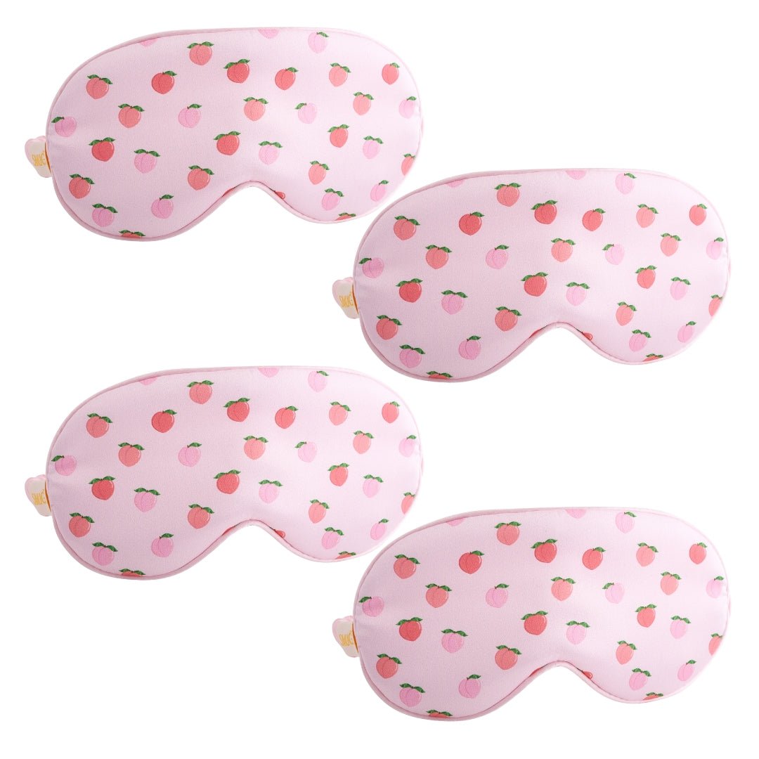 Set of SMUG satin sleep masks in various peachy and stylish designs, perfect for comfortable, restful sleep.