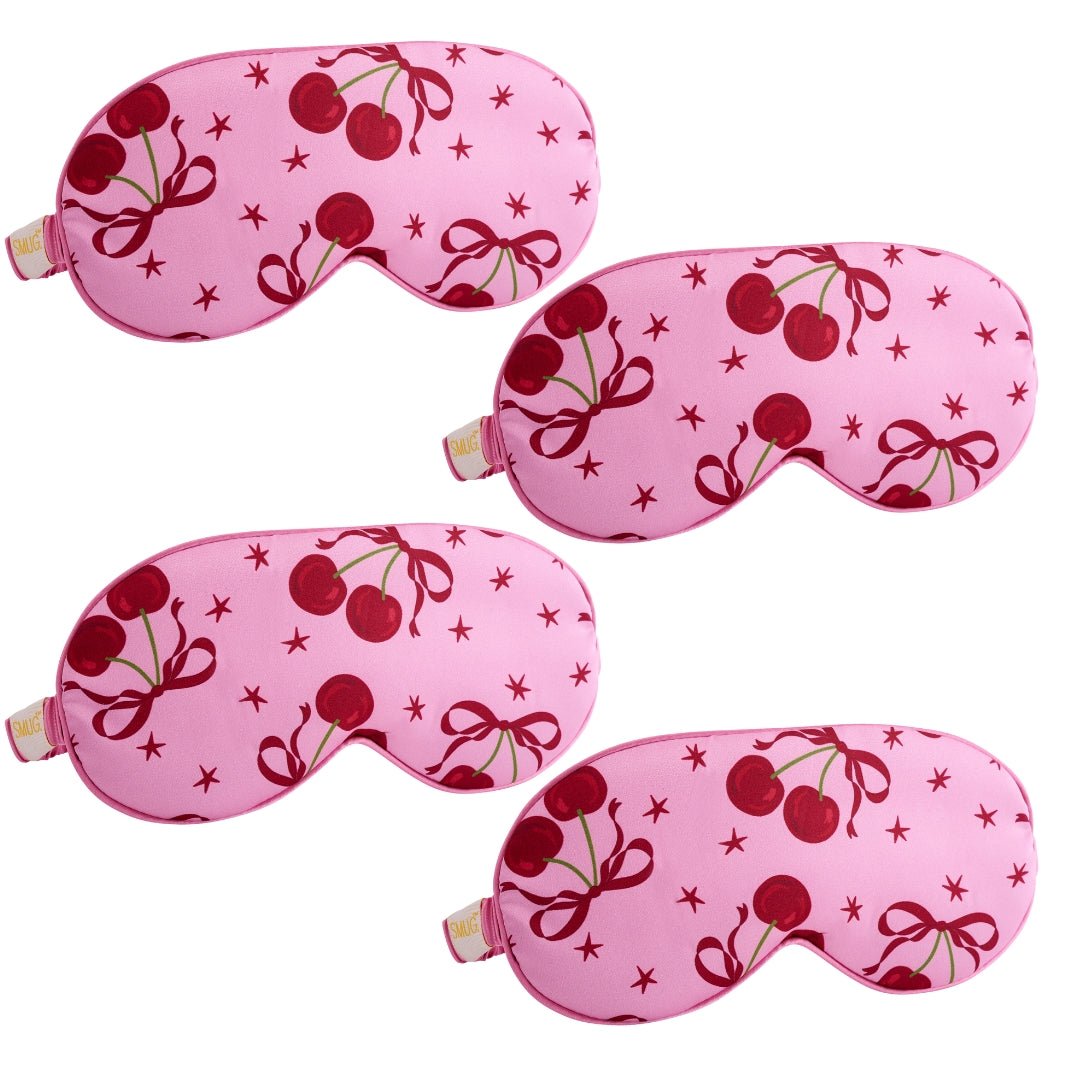 SMUG satin sleep mask set with pink cherry design, featuring multiple comfortable, soft sleep masks for restful nights.