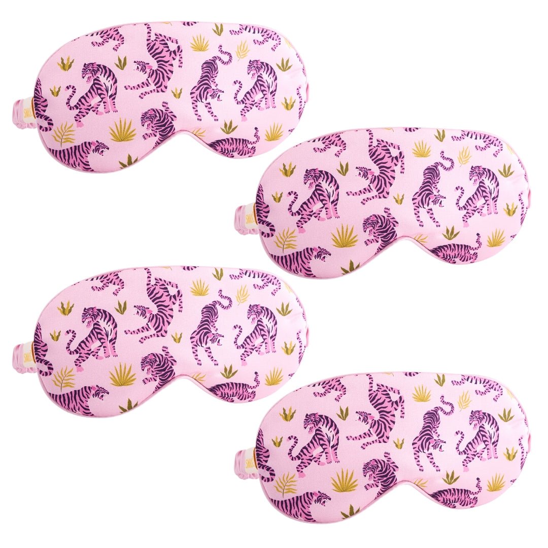 Set of satin sleep masks from SMUG in various designs, featuring a pink tiger pattern for comfortable, stylish sleep accessories.