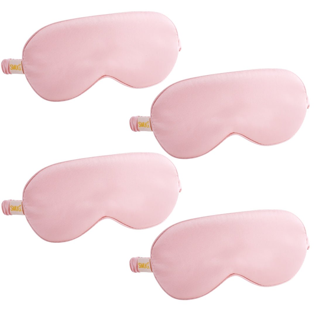 Set of SMUG satin sleep masks in various pink designs, comfortable and soft for restful sleep.