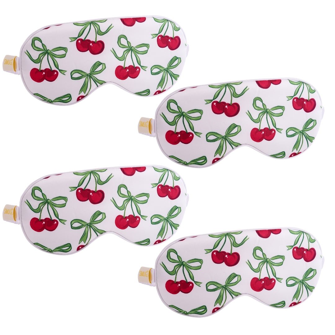 Set of white satin sleep masks with cherry design from SMUG, featuring multiple comfortable sleep mask styles.