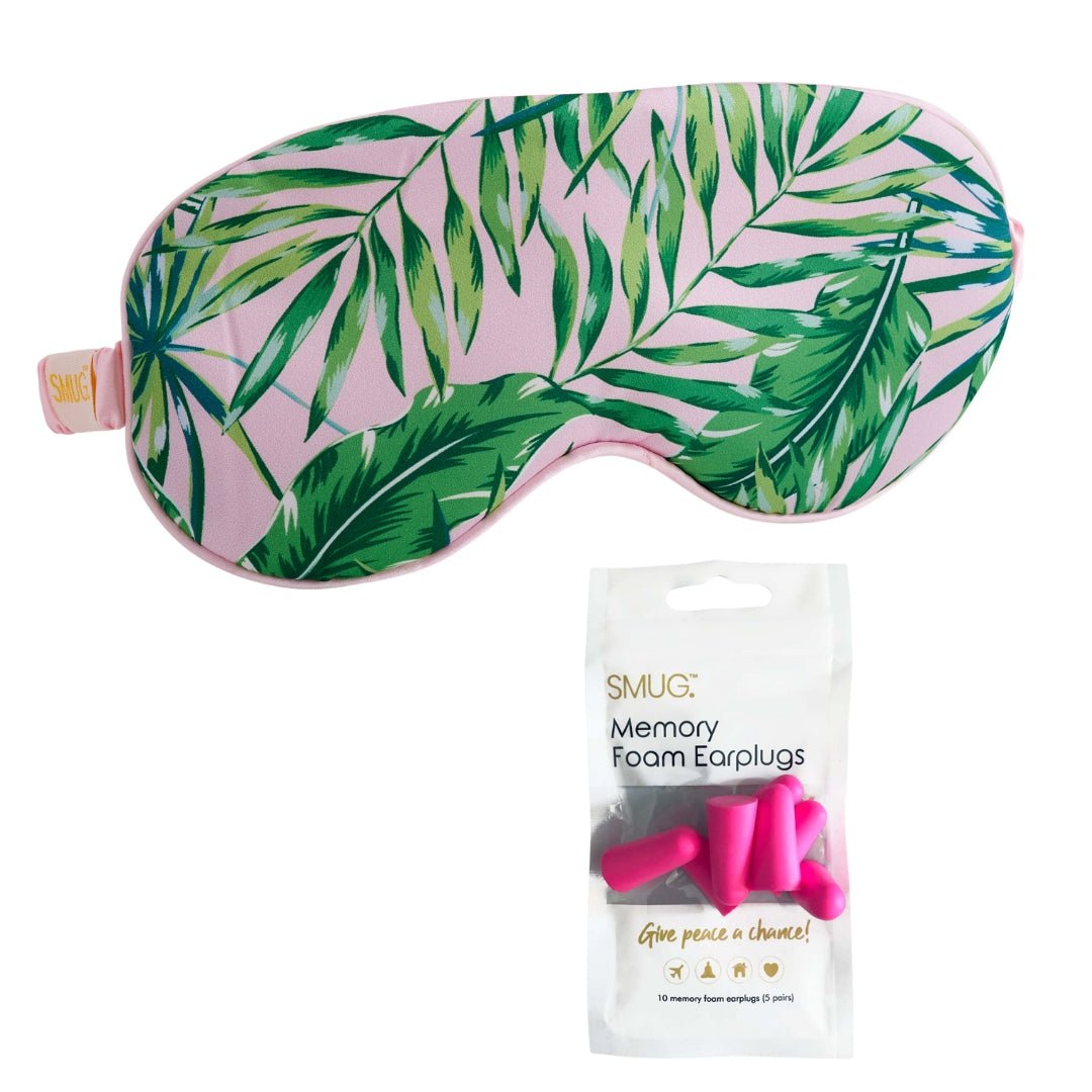 Pink satin sleep mask with palm print from SMUG, featuring adjustable earplugs for comfortable, restful sleep.